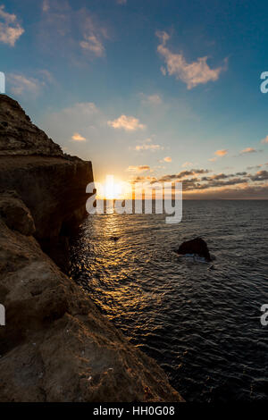 Ocean sunset on Mediterranean sea from Ras lma, rocks coast where people fish Stock Photo