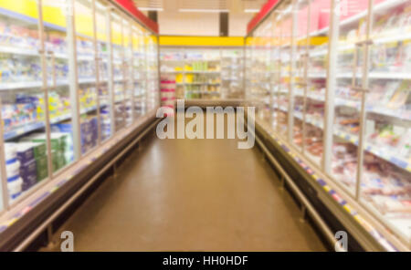 blurred image of  supermarket aisle with shelves full of products Stock Photo