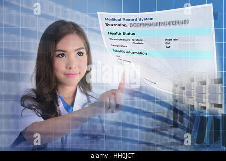 Female doctor searching patient information from electronic medical record system. Stock Photo