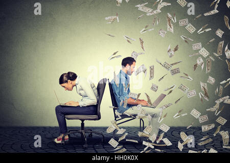 Employee compensation economy concept. Woman working on laptop sitting next to young  man under money rain. Pay difference Stock Photo