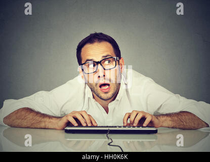 Man typing on the keyboard wondering what to reply Stock Photo