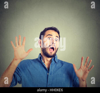 scared man on gray wall background Stock Photo