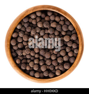 Allspice berries in wooden bowl. Dried unripe fruit, used as spice. Jamaica or myrtle pepper, Turkish yenibahar or newspice. Stock Photo