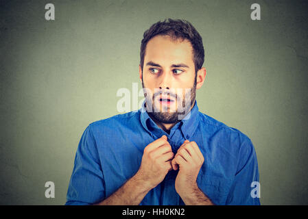 portrait nervous stressed man feels awkward looking sideway anxiously craving something isolated gray background. Human emotion Stock Photo