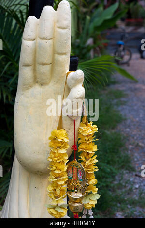 Amulets for good luck hanging on a hand statue. Koh Lanta. Krabi. Thailand. Asia. Ko Lanta is technically called Ko Lanta Yai, the largest of 52 islan Stock Photo