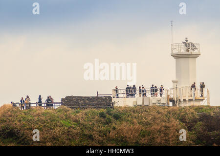 Jeju Island, Korea - November 13, 2016 : The tourist visited Lighthouse, the target of treking in Seopjikoji. Located at the end of the Eastern shore  Stock Photo