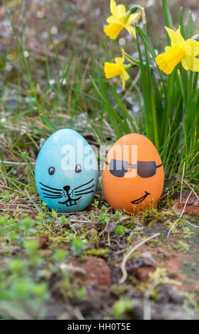 blue and orange Easter egg with funny faces Stock Photo