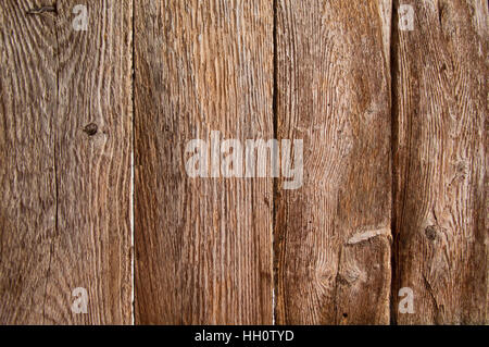 Four vertical very weathered boards inside an old barn door, showing the grain Stock Photo