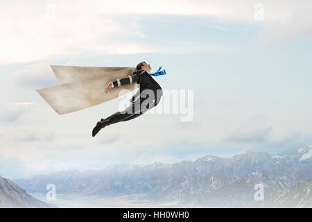 Young businessman with paper wings flying in sky Stock Photo