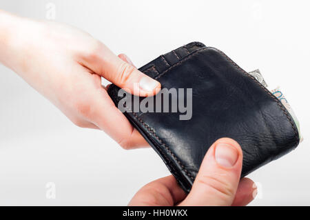 Hand over wallet with money from hand to hand Stock Photo