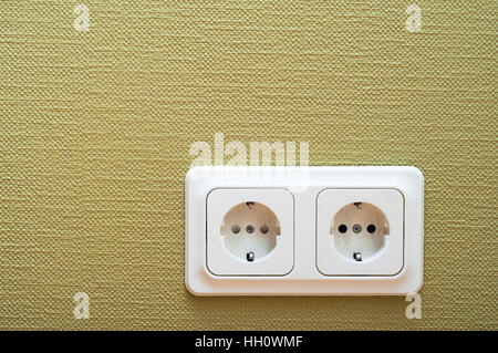 White dual socket on green wall Stock Photo