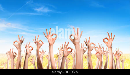 Row of raised hands showing different gestures Stock Photo