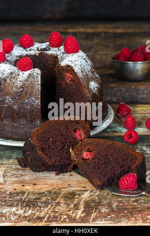 Chocolate and raspberry bundt cake decorated with fresh raspberries Stock Photo