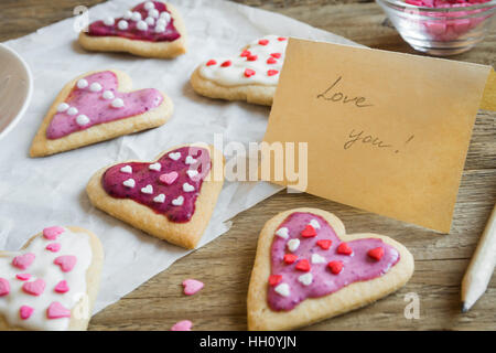 Glazed heart shaped cookies for Valentine's day with text Love you - delicious homemade natural organic pastry, baking with love for Valentine's day Stock Photo