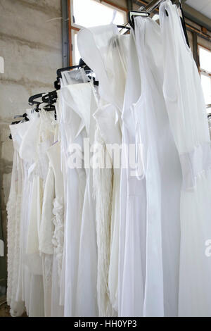 White wedding gowns in a charity shop Stock Photo