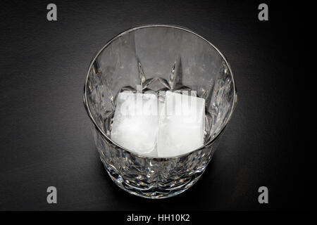 Empty glass of whiskey with two cube of ice Stock Photo