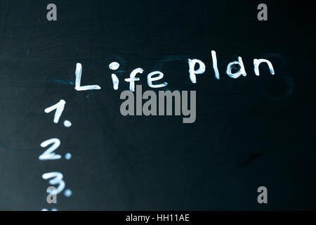 LIFE PLAN phrase written in chalk on the blackboard. Stock Photo