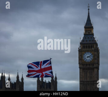 Big Ben at Westminster in the distance with the Union Flag in the foreground blowing in the wind Stock Photo