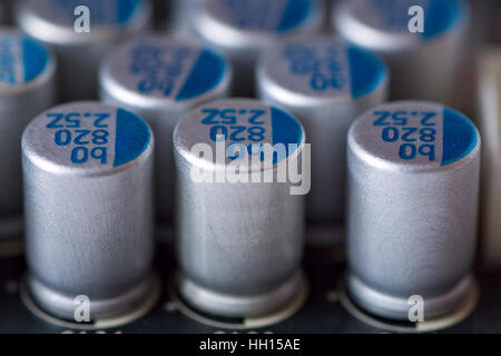 Rows of electrolytic capacitors mounted on the circuit board Stock Photo