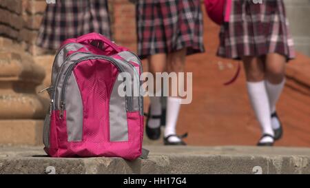 Female Students Walking Towards Backpack Stock Photo