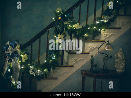 Christmas garland going up staircase Stock Photo