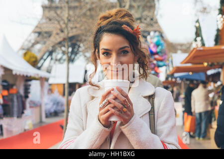 Paris, Woman doing shopping in Christmas market Stock Photo