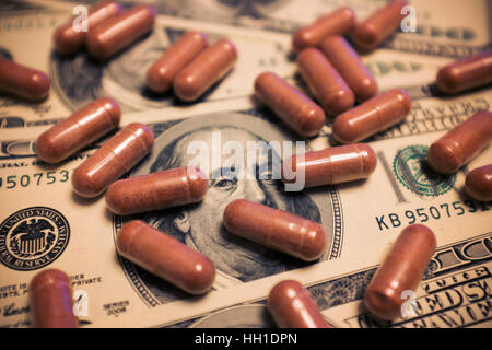 Capsule on the one hundred dollars bills Stock Photo
