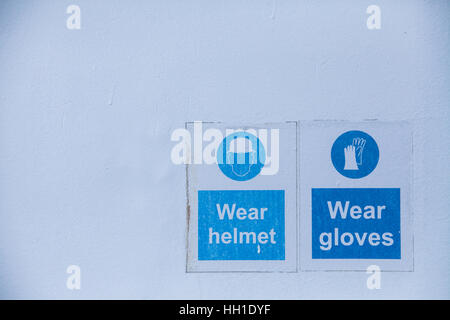 Close up shot of some signs with mandatory helmet and gloves. Stock Photo