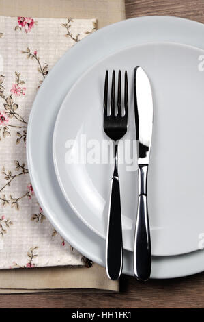 Dining etiquette - I still eat, finished. Fork and knife signals with location of cutlery set. Stock Photo