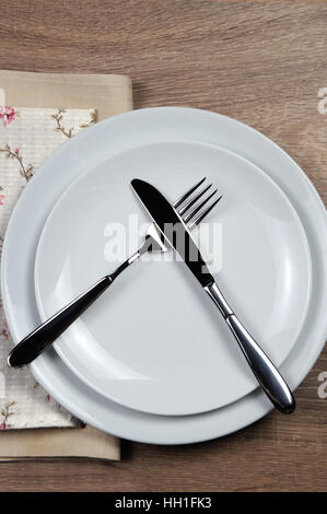 Dining etiquette - I still eat, do not like. Fork and knife signals with location of cutlery set Stock Photo