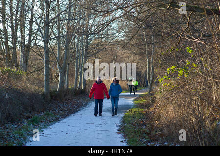 Walkers and cyclists  on the Deeside way at Cults, Aberdeen. Former Royal Deeside Railway line running from Aberdeen to Ballater in Scotland Stock Photo