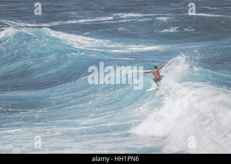 MAUI, HI - MARCH 10, 2015: Professional surfer rides a giant wave at the legendary big wave surf break 'Jaws' in Maui, HI.USA. Stock Photo