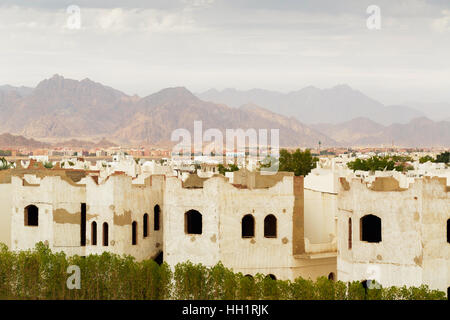 City landscape with low-grade houses in Egypt against mountains Stock Photo