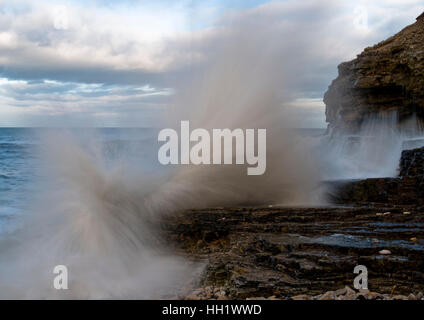 Wave smashing against rocks. Stock Photo