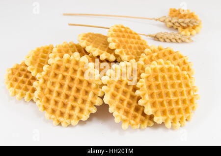 Bunch of golden baked waffle cookies on white Stock Photo