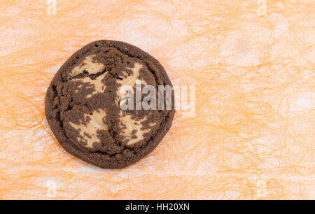 Chocolate chip brown cookie on orange background Stock Photo