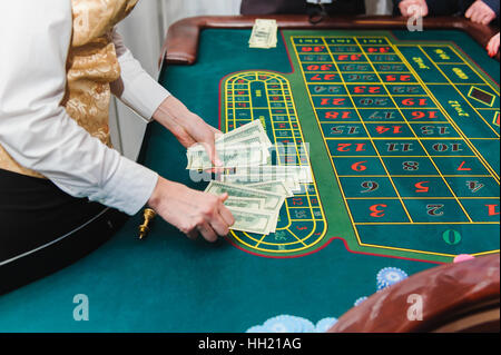 Croupier counts the money. Game of roulette. Table roulette Stock Photo