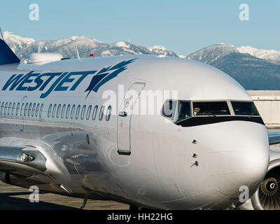WestJet Airlines plane airplane Boeing 737 (737-700) airliner taxiing along the tarmac, Vancouver International Airport Stock Photo
