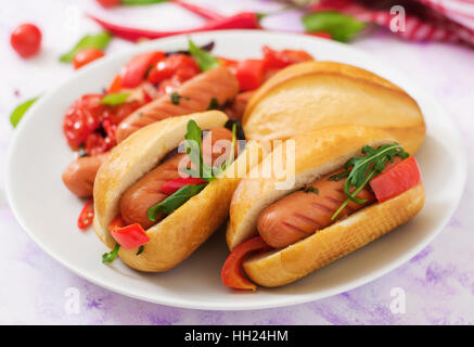 Hot dog with sausage and vegetables in the Greek style. Stock Photo