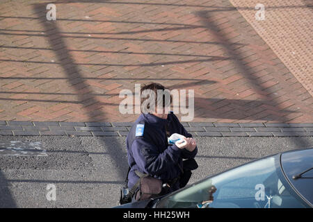 Traffic Warden Issuing a parking ticket Stock Photo