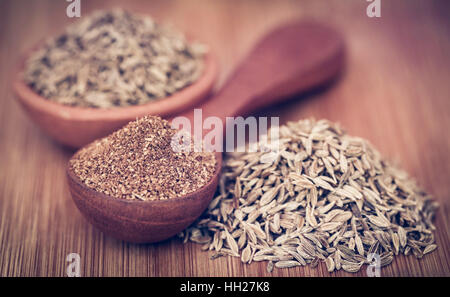 Closeup of crushed cumin with whole ones Stock Photo