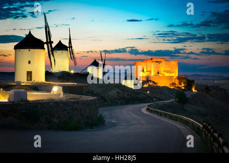 Windmills and castle after sunset, Consuegra, Castile-La Mancha, Spain Stock Photo