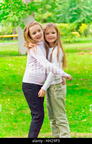 Photo of two embracing girls in summer Stock Photo - Alamy