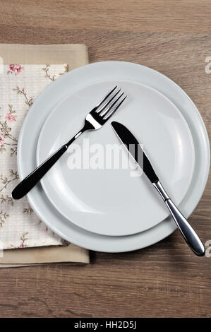 Dining etiquette - I still eat, pause. Fork and knife signals with location of cutlery set Stock Photo