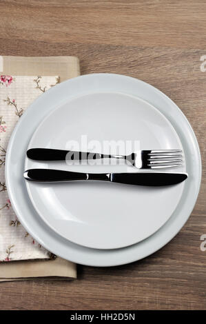 Dining etiquette - I still eat, finished  . Fork and knife signals with location of cutlery set Stock Photo