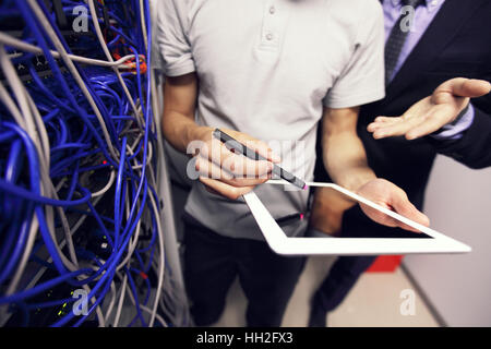 Engeneer and business man in network server room with digital tablet Stock Photo
