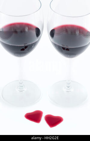 Two glasses and Heart shape from red wine on white background, Happy Valentine's Day Stock Photo