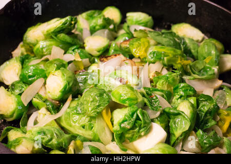 Brussel sprouts being cooked in a skillet with real butter in a home kitchen. Stock Photo