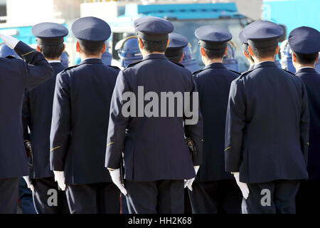 Back view of Japanese police officers stand in a row Stock Photo