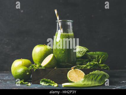Green smoothie in glass bottle with apple, romaine lettuce, lime Stock Photo